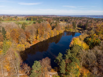 High angle view of trees by lake against sky