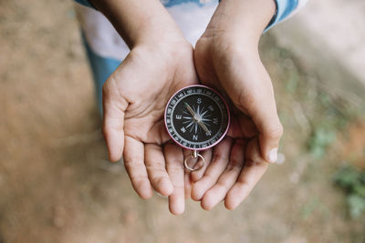 Close-up of hand holding clock