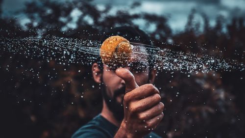 Man playing with wet tennis ball