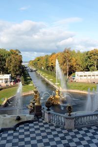 Water fountain in park against sky