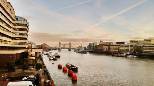 Panoramic view of city by river against sky