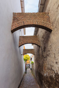 Rear view of narrow alley amidst buildings