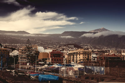 High angle view of houses in town against sky