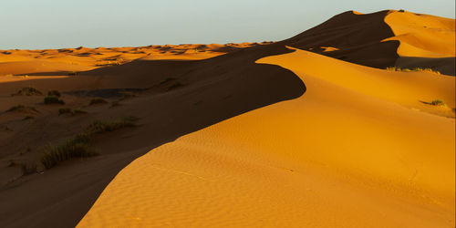 Scenic view of desert against clear sky