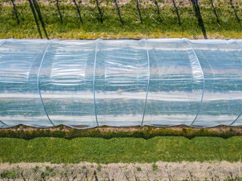 Scenic view of field seen through glass window