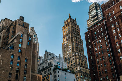 Low angle view of buildings against clear sky in city