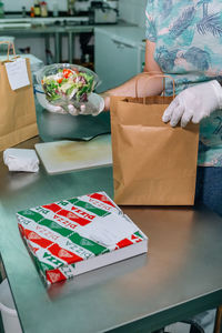 Midsection of man preparing food at restaurant