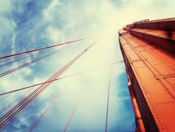 Low angle view of bridge against cloudy sky