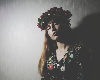 Portrait of young woman with red rose