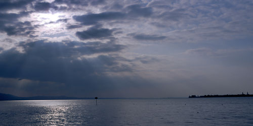 Scenic view of sea against storm clouds