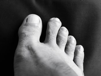Close-up of human hand against black background