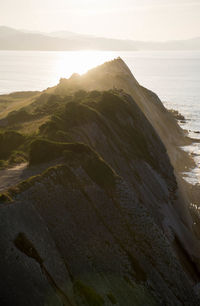 Scenic view of sea and mountains against sky