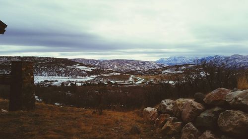 Scenic view of mountains against cloudy sky