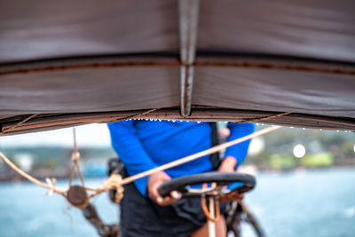 Midsection of man standing in boat