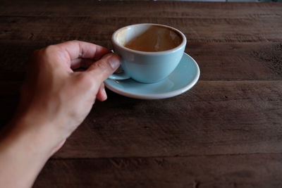 Midsection of coffee cup on table