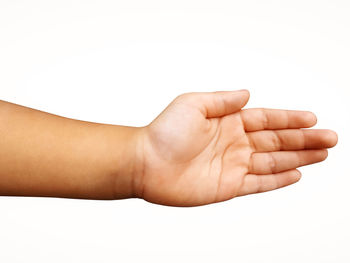 Close-up of hand holding hands over white background