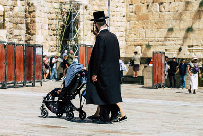 Side view of men walking in city