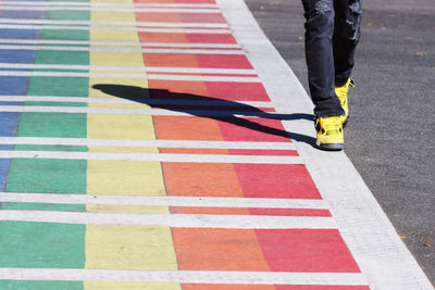 Low section of man walking on street