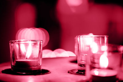 Close-up of candles toned in viva magenta color of 2023