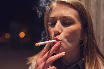 Close-up of woman smoking cigarette