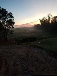 Scenic view of field against sky during sunset