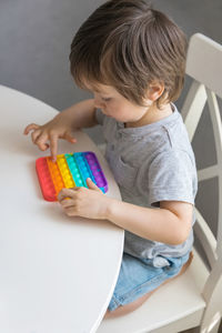 High angle view of boy playing with toy