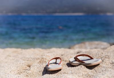 High angle view of shoes on sand at beach