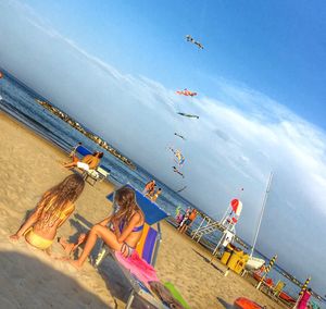 People on beach against sky