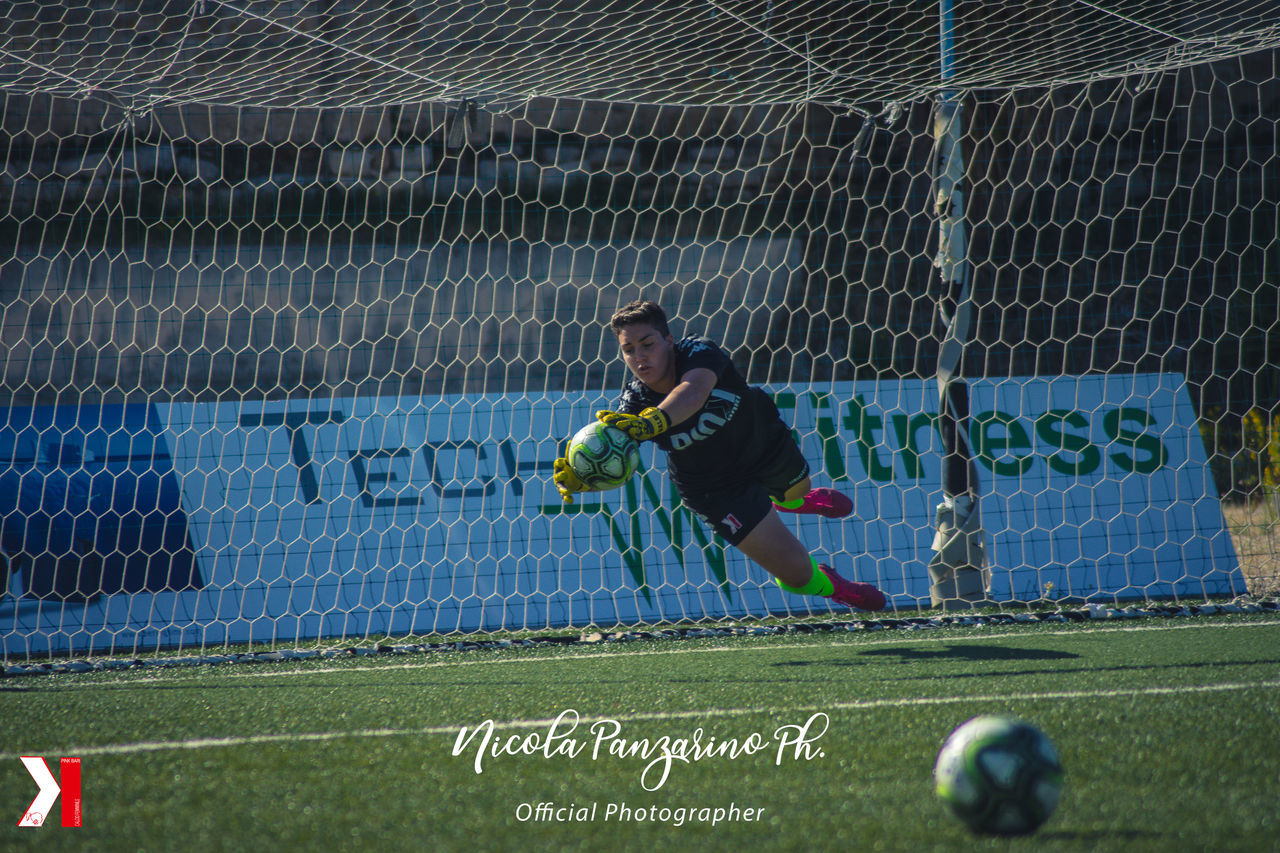 MAN PLAYING SOCCER ON FIELD