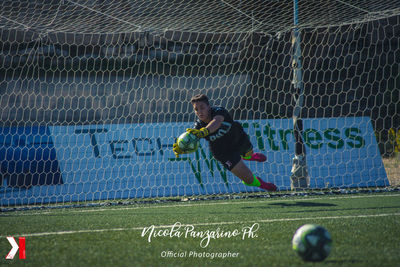 Man playing soccer ball on field