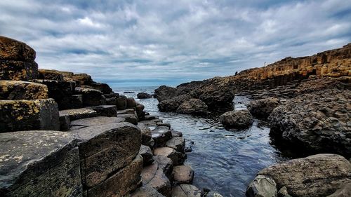 Rocks on beach against sky