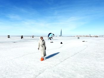 People skiing on snow covered landscape