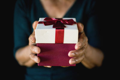 Close-up midsection of woman holding gift box