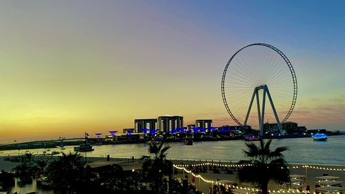 Ferris wheel in city at sunset