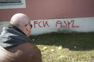 Portrait of man with text on grass