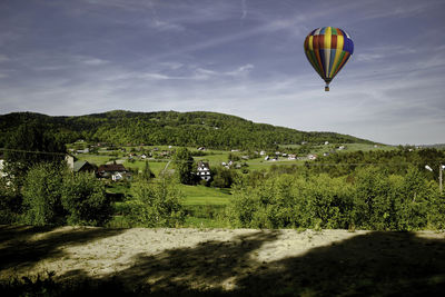 Wide angle shot of landscape with air balloon - limanowa, poland - central europe