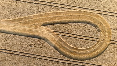 High angle view of tire tracks on sand