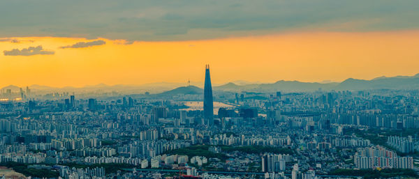 Aerial view of city against sky during sunset