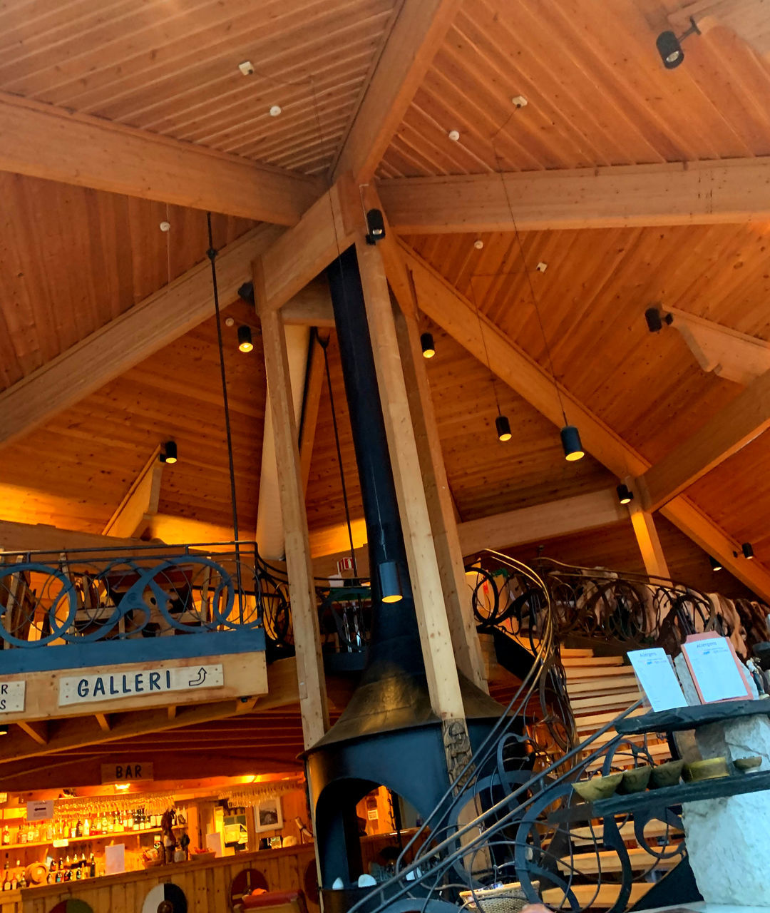 LOW ANGLE VIEW OF ILLUMINATED LIGHTS HANGING ON CEILING OF BUILDING
