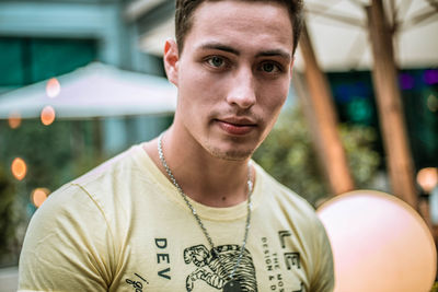 Close-up portrait of young man standing outdoors