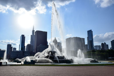 Panoramic view of fountain against buildings in city