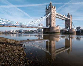 Bridge over river with city in background