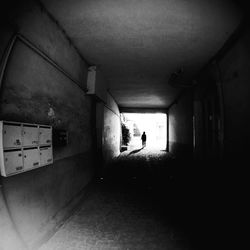 Full length of people walking in tunnel