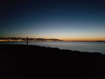 Scenic view of sea against clear sky during sunset