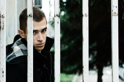 Close-up of young man against window