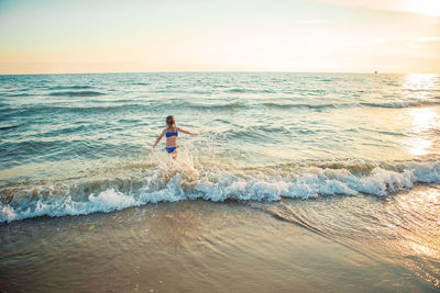 Man surfing in sea against sky
