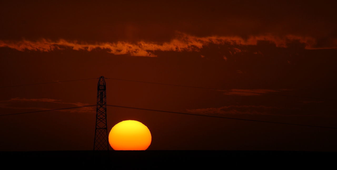 LOW ANGLE VIEW OF SILHOUETTE ELECTRICITY PYLON DURING SUNSET