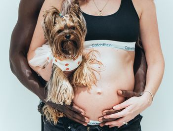 Midsection of woman holding dog