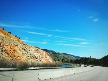 Scenic view of mountains against blue sky