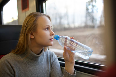 Close-up portrait of woman on train